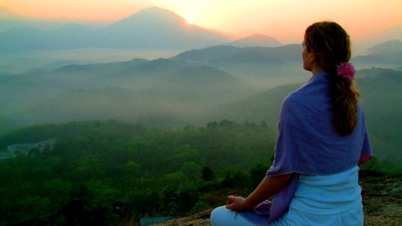 Woman Meditating Overlooking Mountains