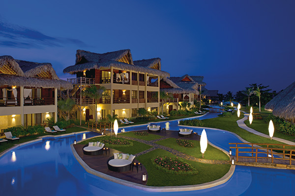 The pools in front of the Zoetry Agua resort at night